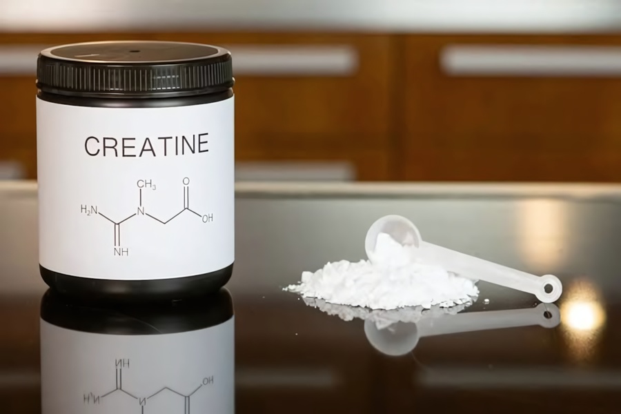 A clean, studio-lit shot of a creatine powder jar with a measured scoop of product, emphasizing ingredient purity and scientific clarity.